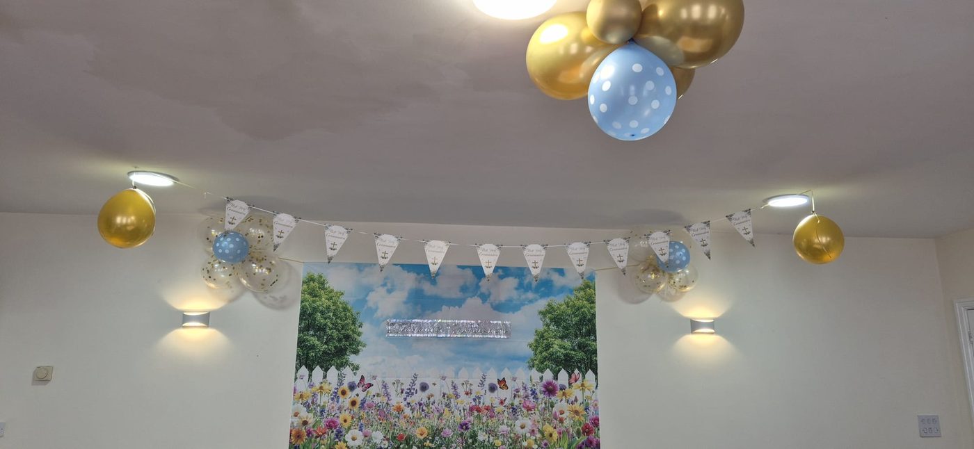 First Holy Communion bunting and garden backdrop in the hall