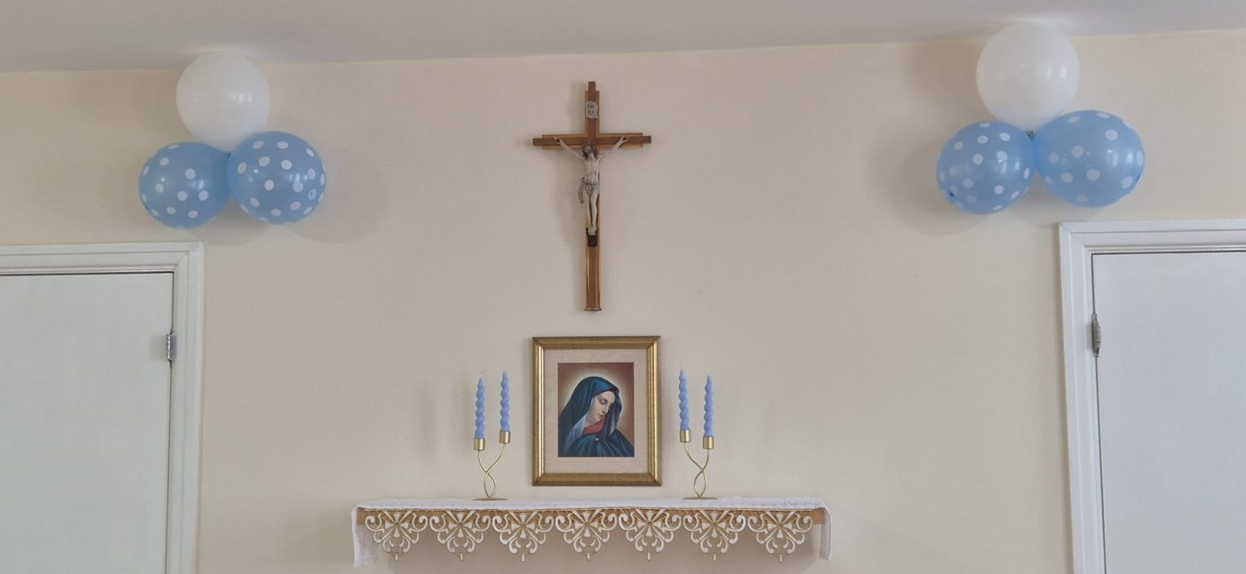 Chapel shrine dressed with candles and balloons for Holy Communion