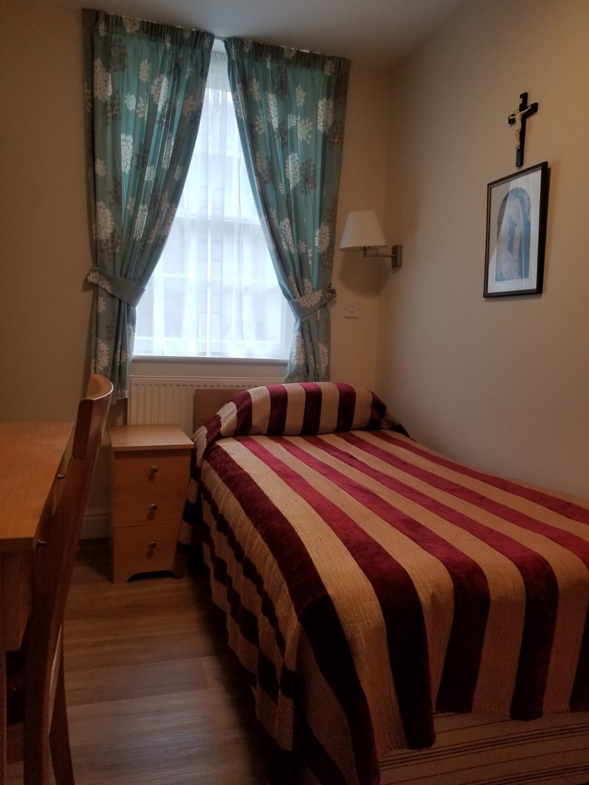Single room with striped bedspread