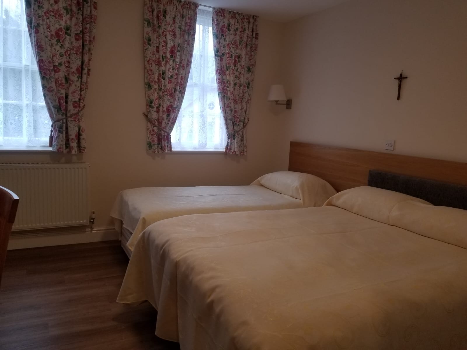 Twin room with floral curtains