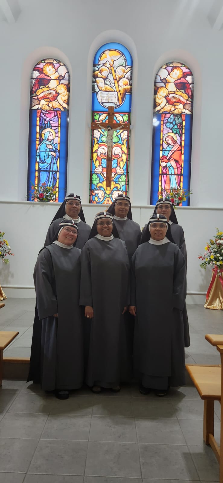 Sisters in front of stained glass