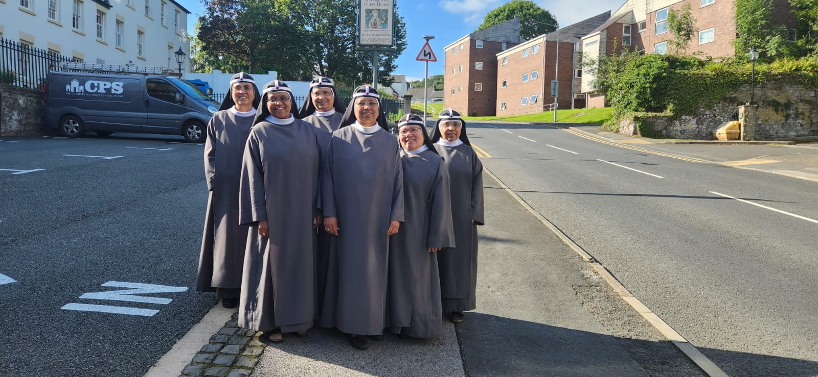 Sisters outside guest house on New Road